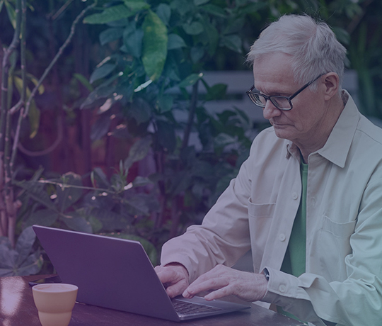 Person at laptop sitting outside