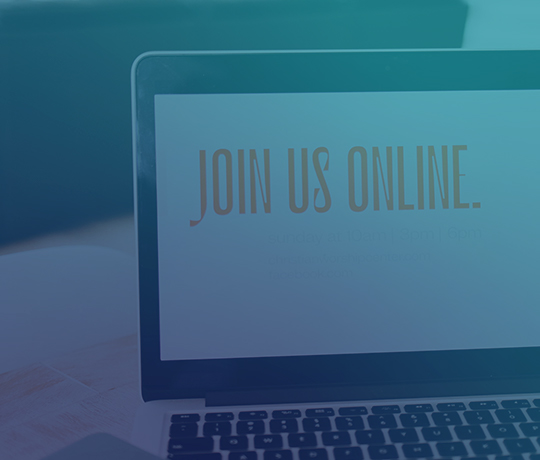 Close up of laptop with "join us online" shown on the screen