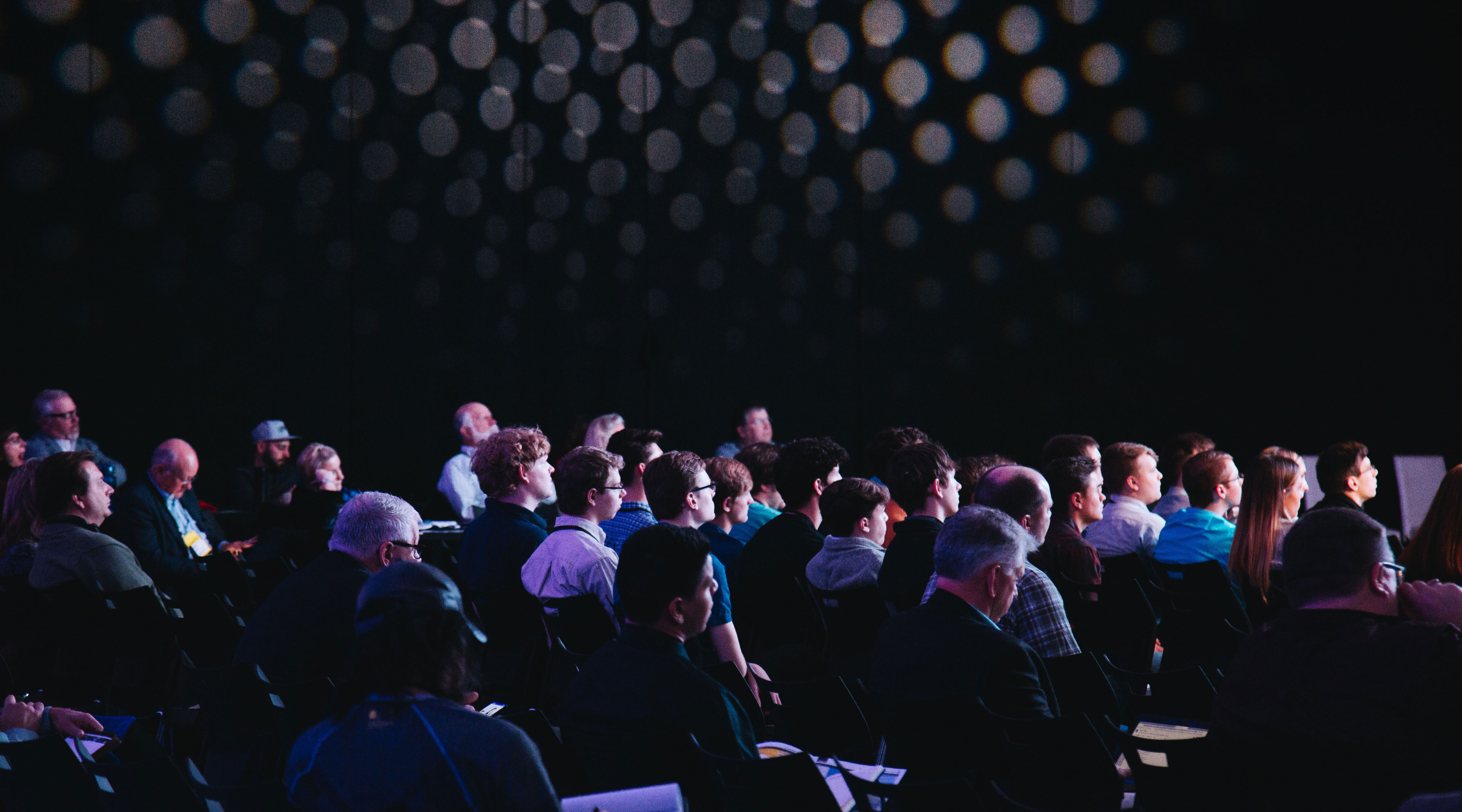Crowd of people facing a stage at an association event