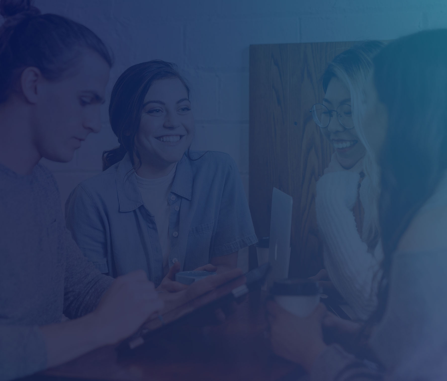 Group of people collaborating around a computer