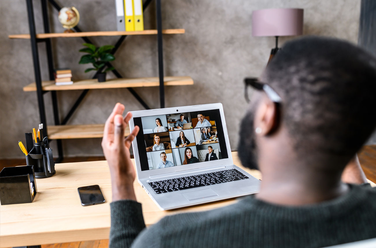 Man presenting to a screen of viewers