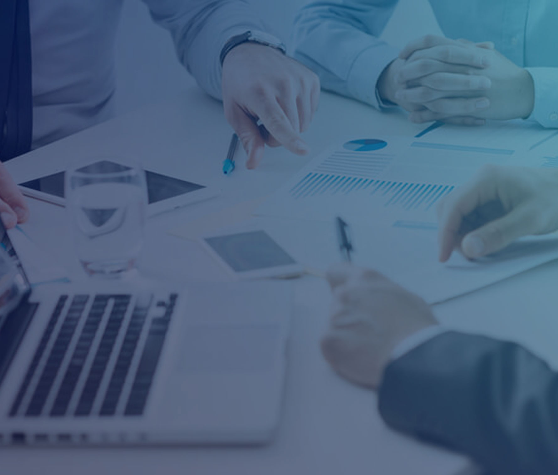 Three people's hands at a desk with papers and a laptop exploring the membership lifecycle.