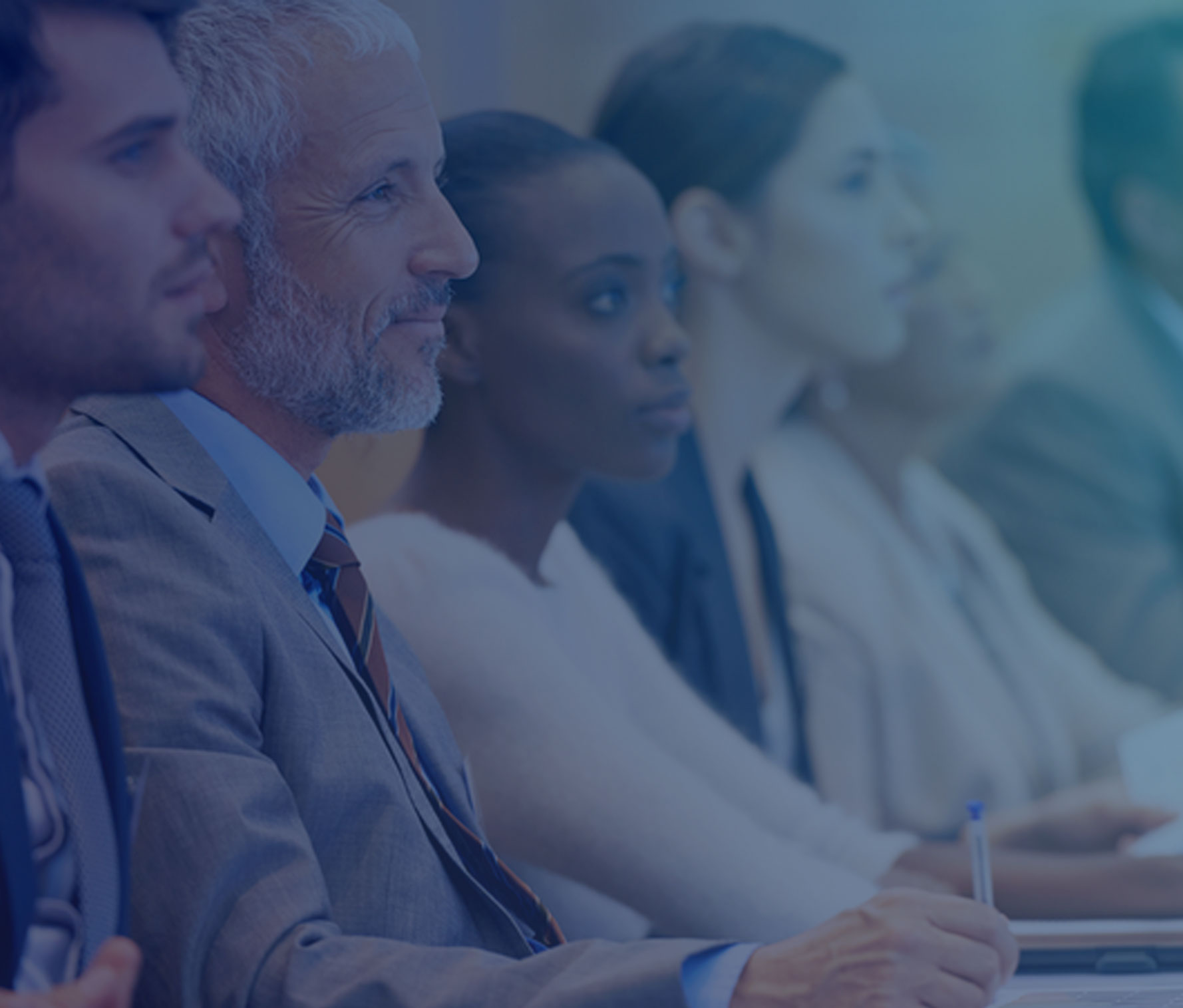 Association members listening to a speaker at a continuing education class and taking notes.